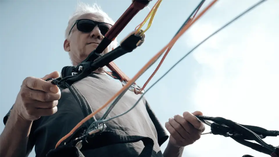 An elderly man kiteboarding for an image film cologne produced for Adito software company.